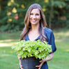 Tiffany-Gieser-Founder-CEO-Abundant-Earth-Labs-holding-plant-outside