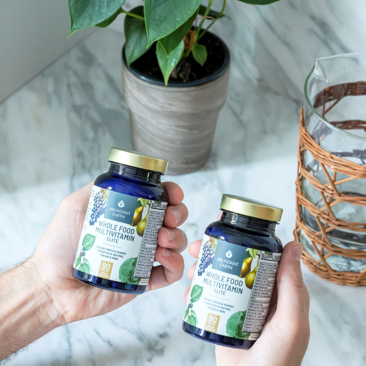 man-holding-abundant-earth-organic-vitamins-bottles-over-counter